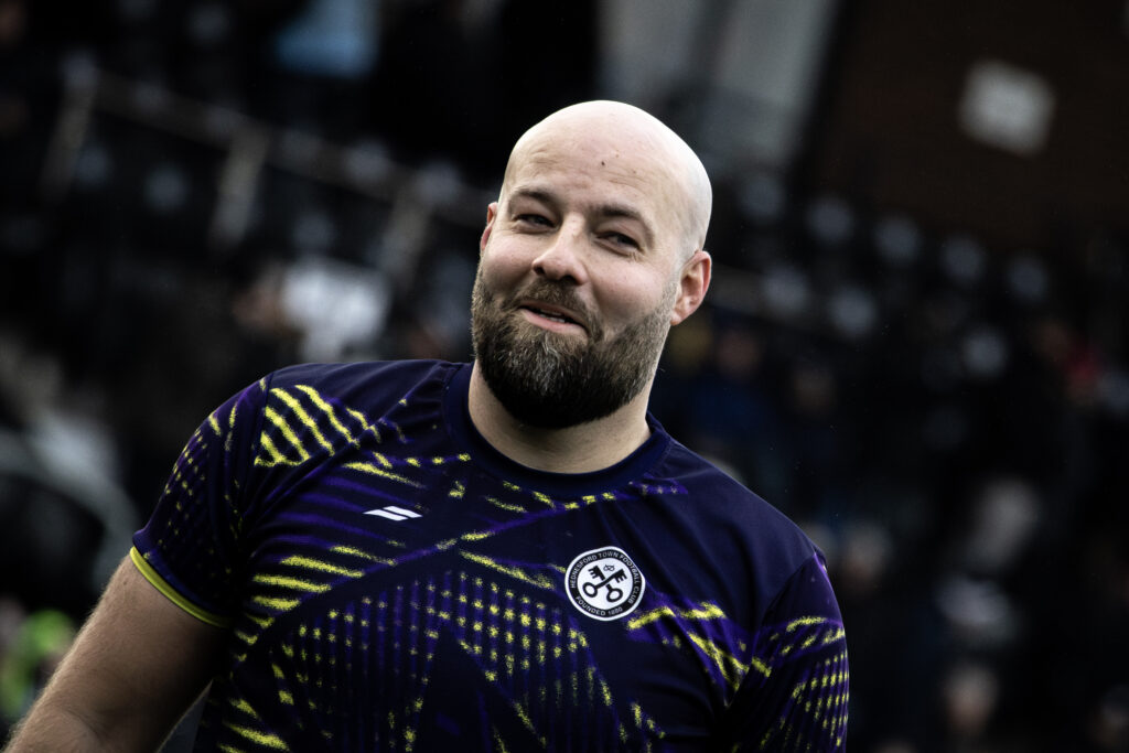 Football player on field smiling