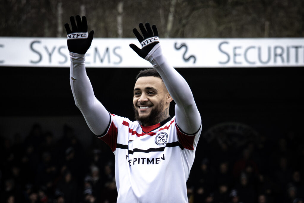 Football player celebrating with hands up